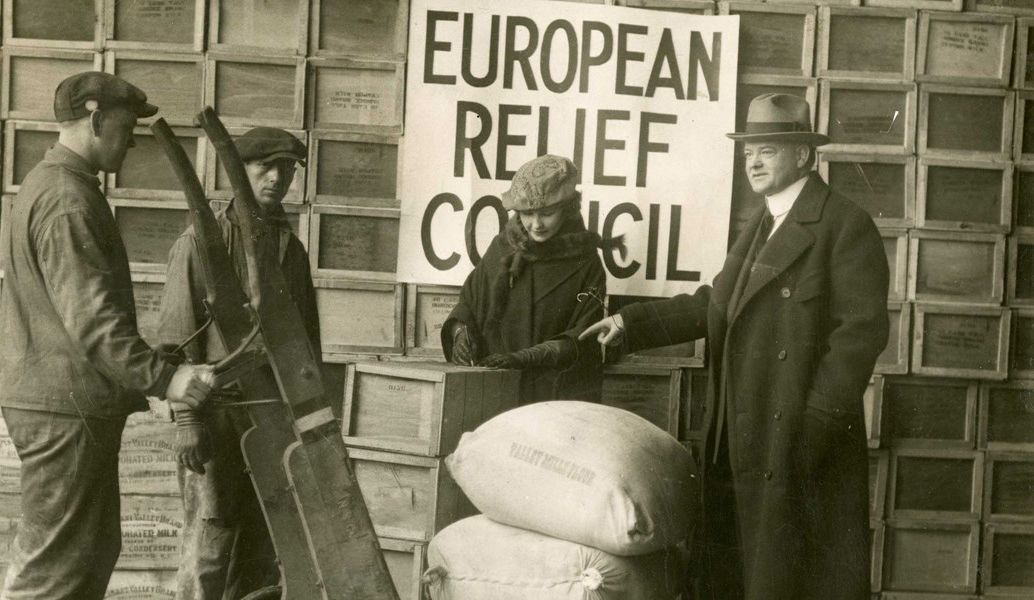 Photograph of Herbert Hoover overseeing the shipping of relief supplies to post-war Europe from NY, 1920. From the Herbert Hoover Presidential Library