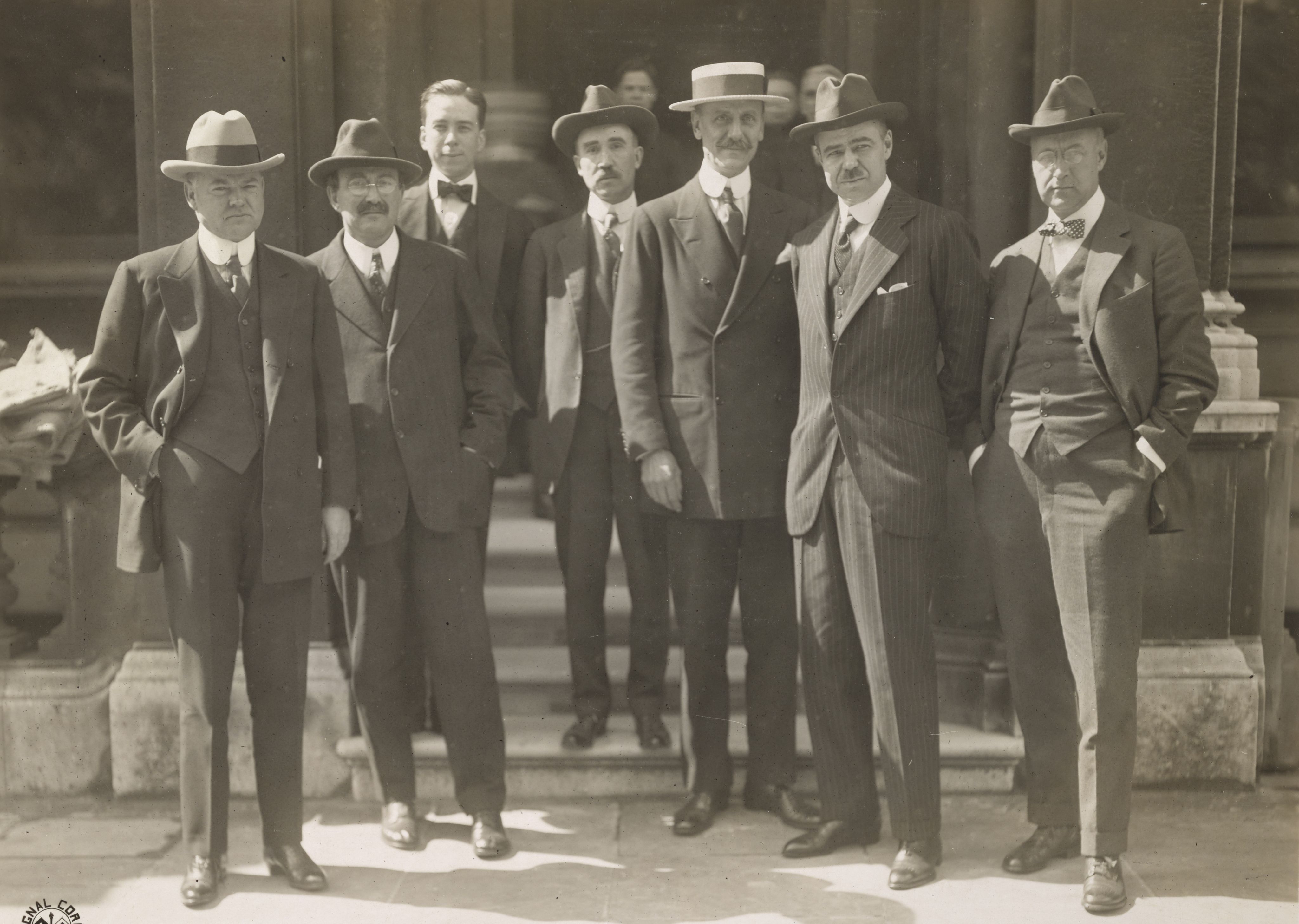 Black and white photograph taken in 1918 of Left to right: Herbert Hoover, Dr. Alonzo E. Taylor, Lewis L. Strauss, Dr. E. Dana Durand, unidentified, James Ford Bell, and Joseph P. Cotton. 