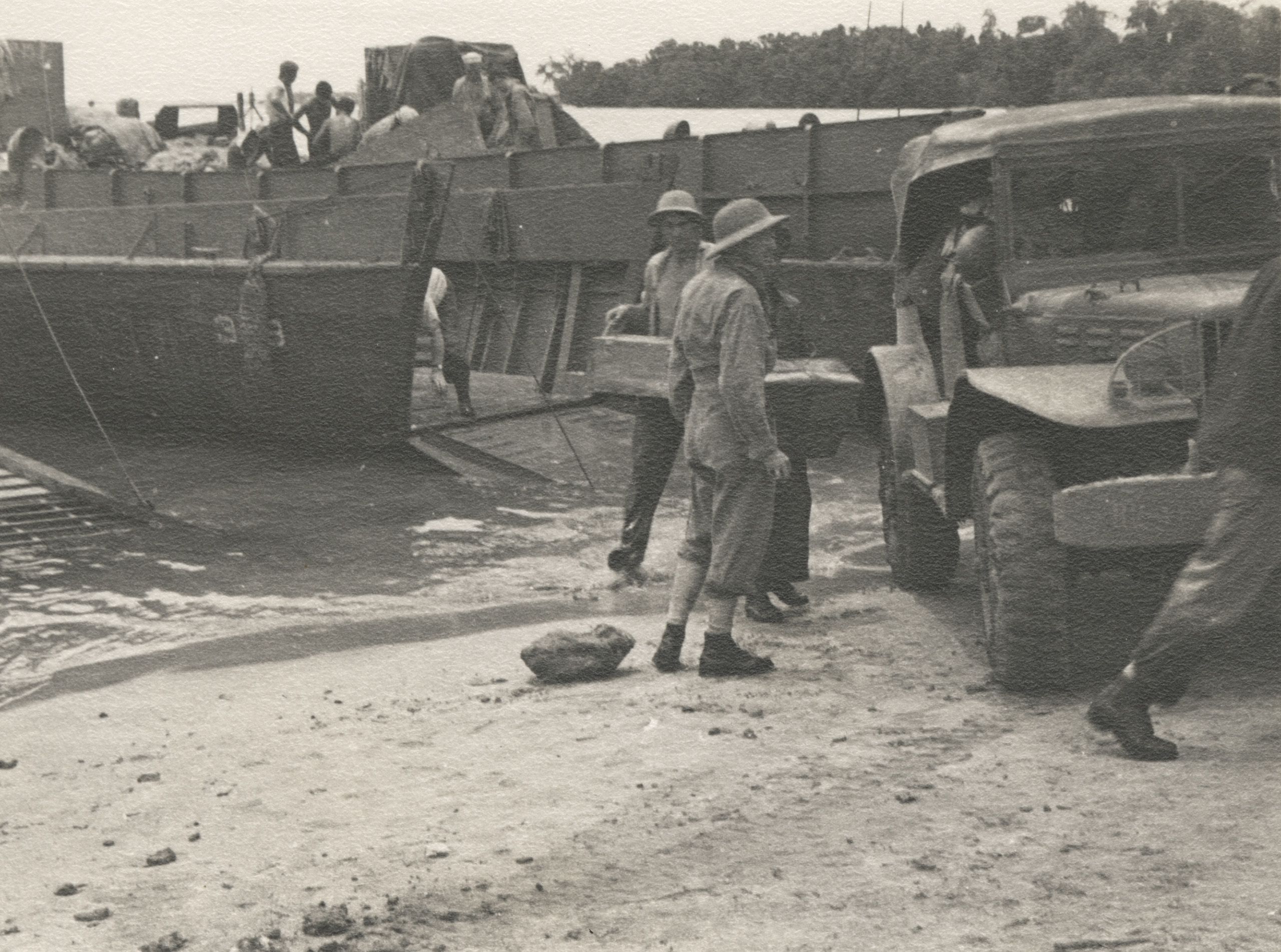 Survey party unloading their gear before starting preliminary surveys on Manus lsle, Barber and Brooks in foreground, by William. S. Snell, 1944.