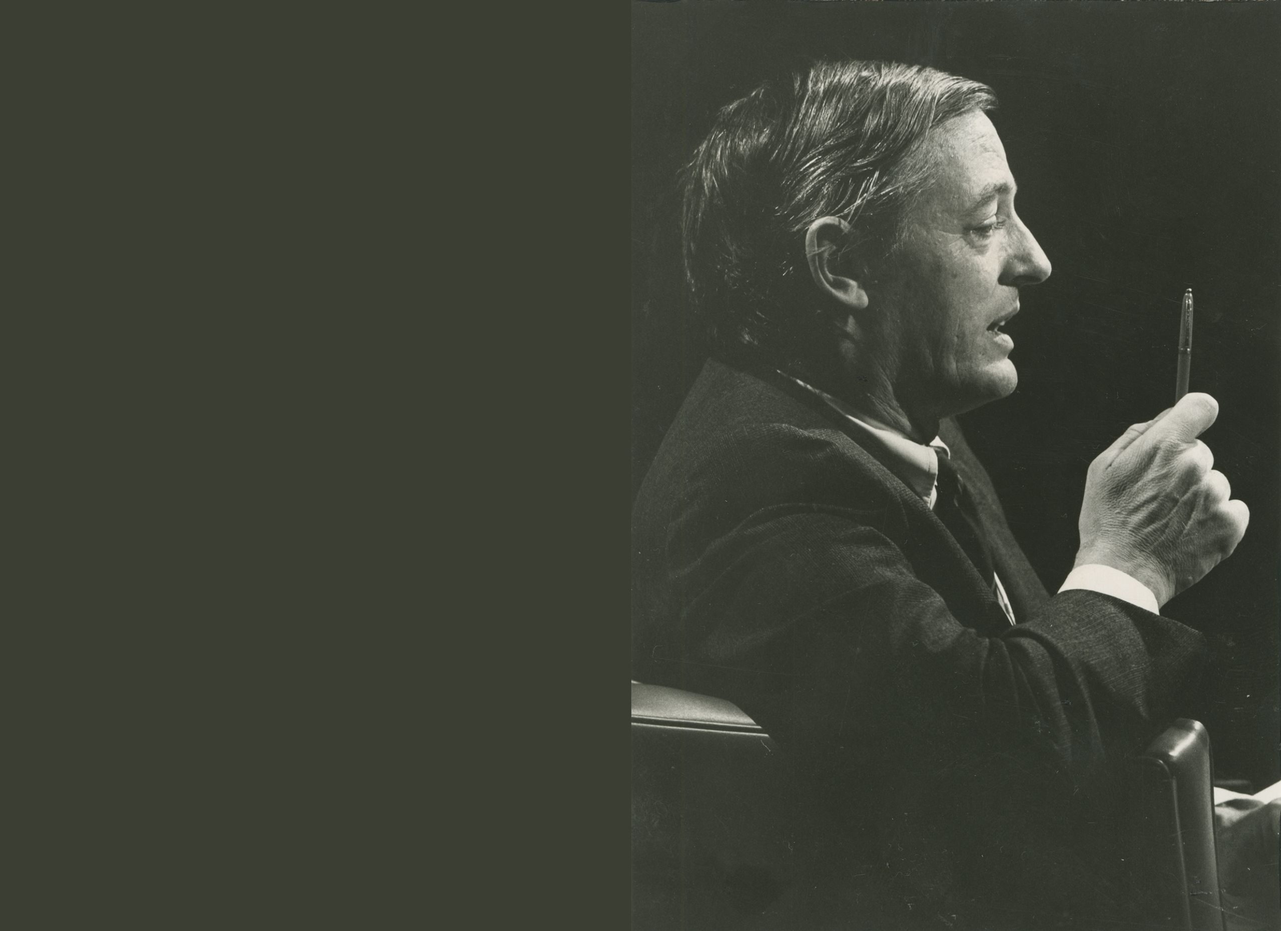 Photograph of William F. Buckley Jr. holding a pen.