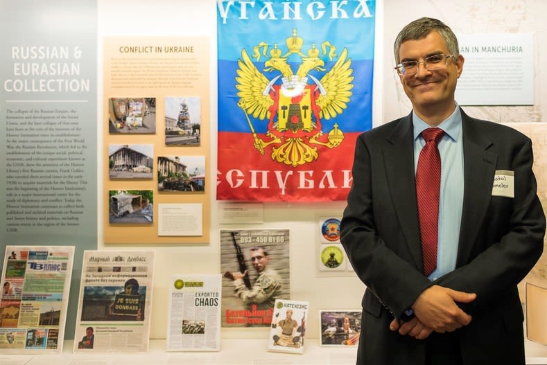 Photograph of Curator Anatol Shmelev with newly acquired collection materials, 2017.