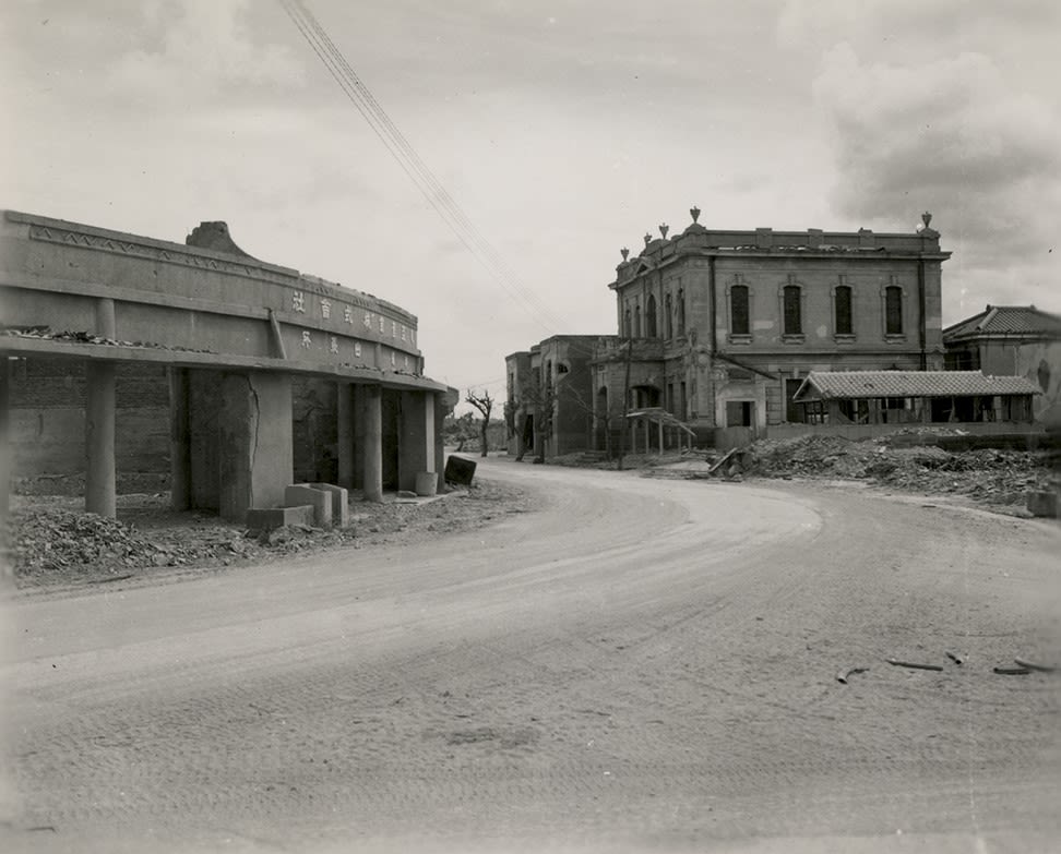 Black and white photograph of a bombed out city street on Okinawa, 1945.