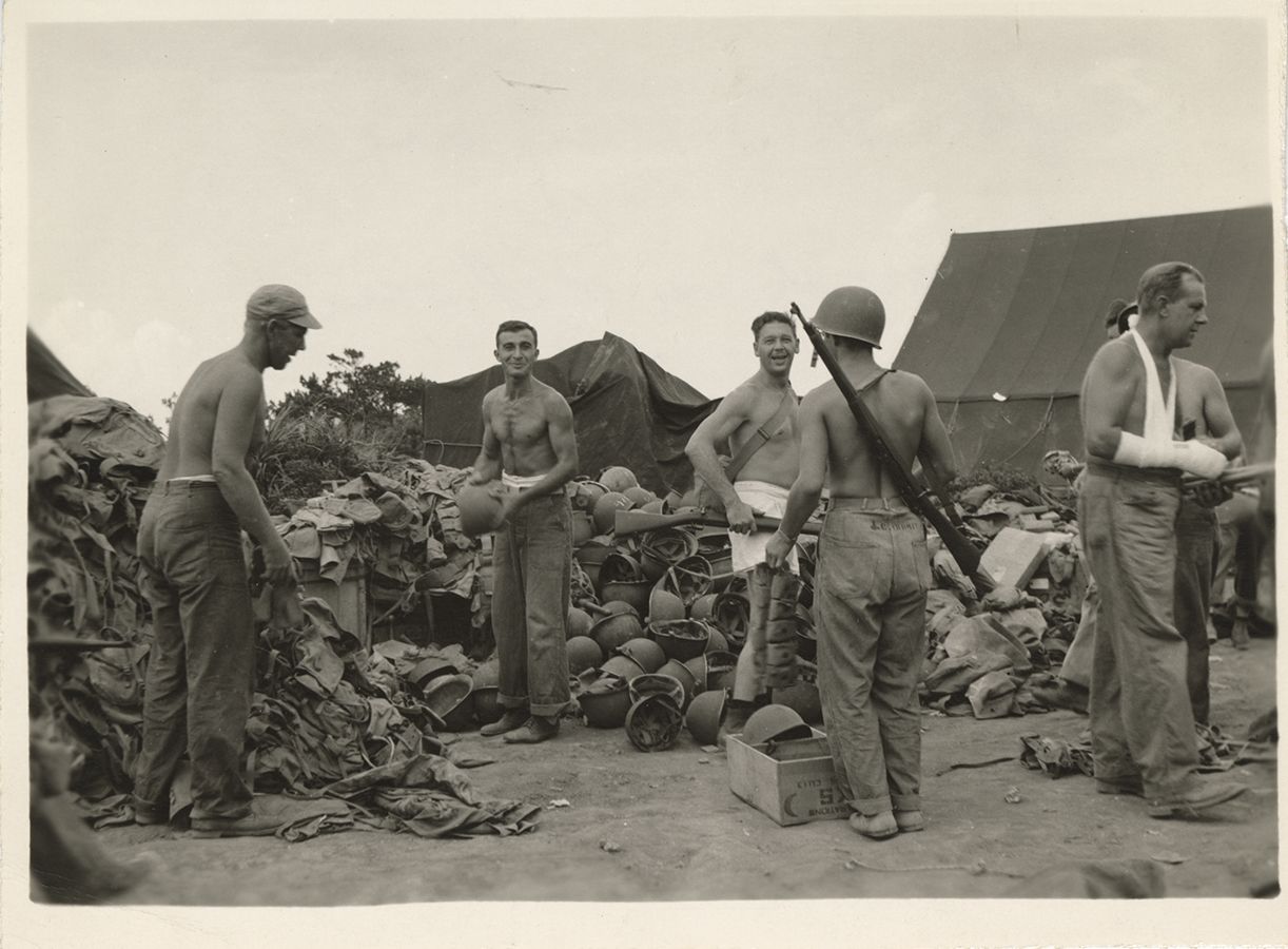 Black and white photograph showing Seabees turning in their GI equipment after V-J Day, 1945.
