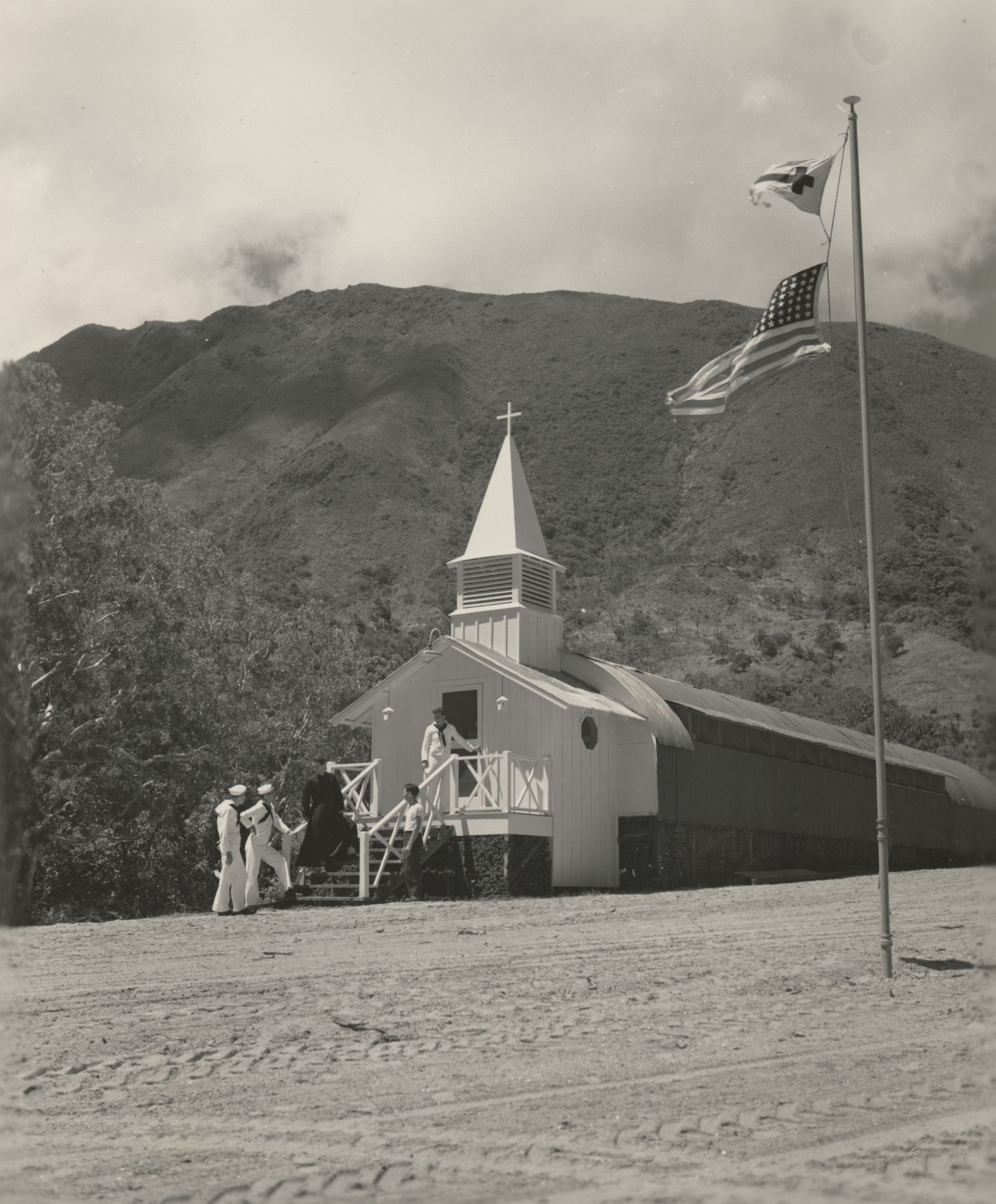 Black and white photograph of five seabees standing in front of the Mont D'Ore Chapel, New Caledonia, 1945.