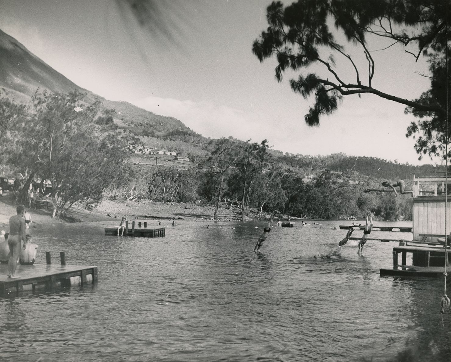 Black and white photograph of swimmers at the Dumbea beach swimming hole, New Caledonia, 1945.