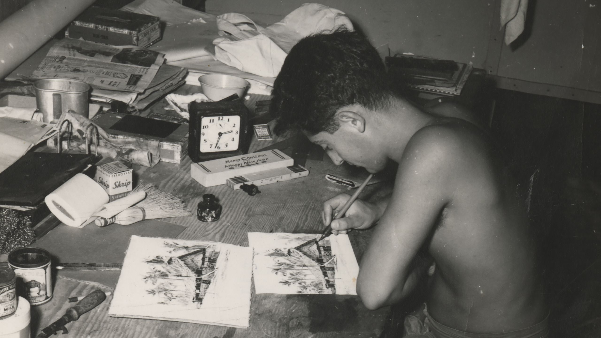 Black and white photograph of Nat Bellantoni drawing Cathedral Square at his desk, 1944.