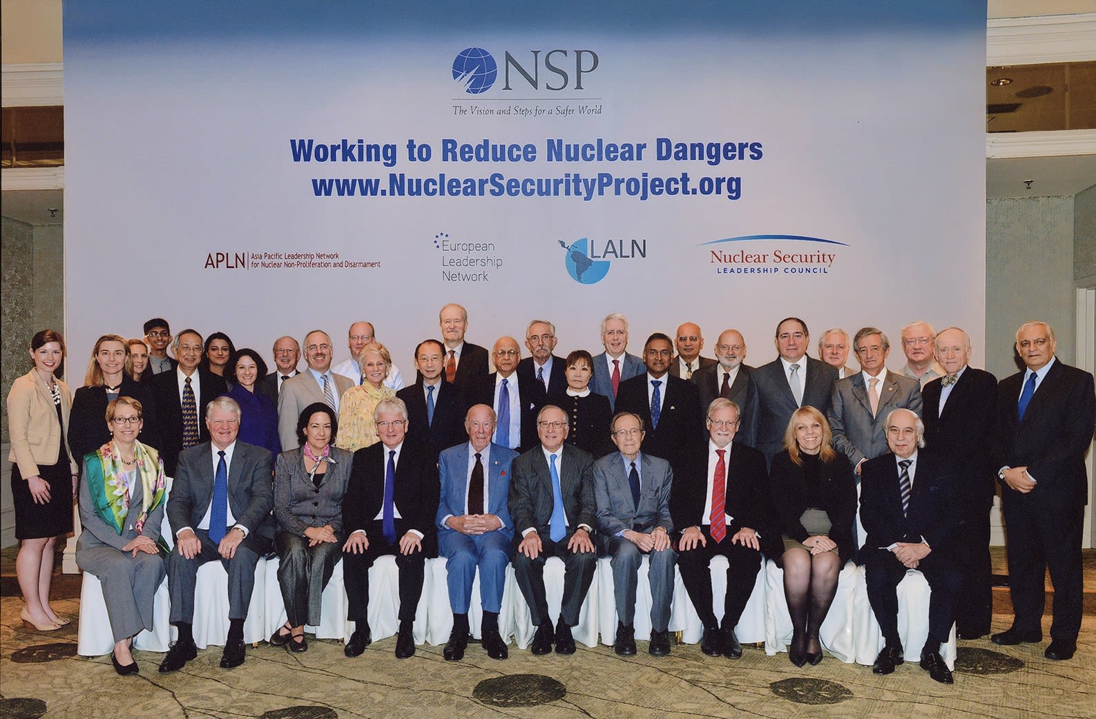 Color photograph of Nuclear Security Project Members, with cofounders George Shultz, Sam Nunn, and William Perry seated at center. n.d. From the George Pratt Shultz Papers, Hoover Institution Archives