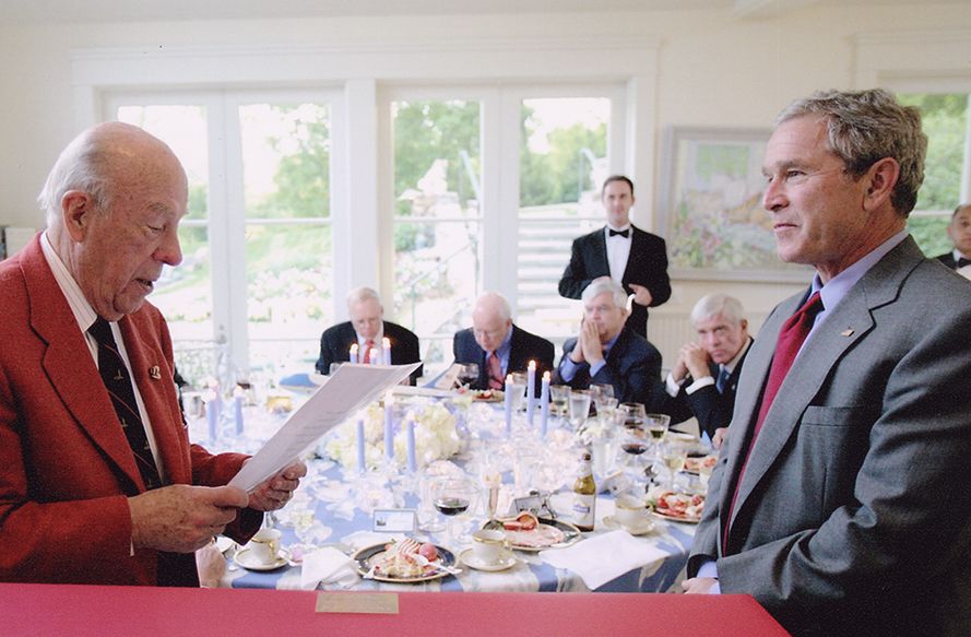 Color photograph George Shultz speaking with President George W. Bush. April 21, 2006 From the George Pratt Shultz Papers, Hoover Institution Archives