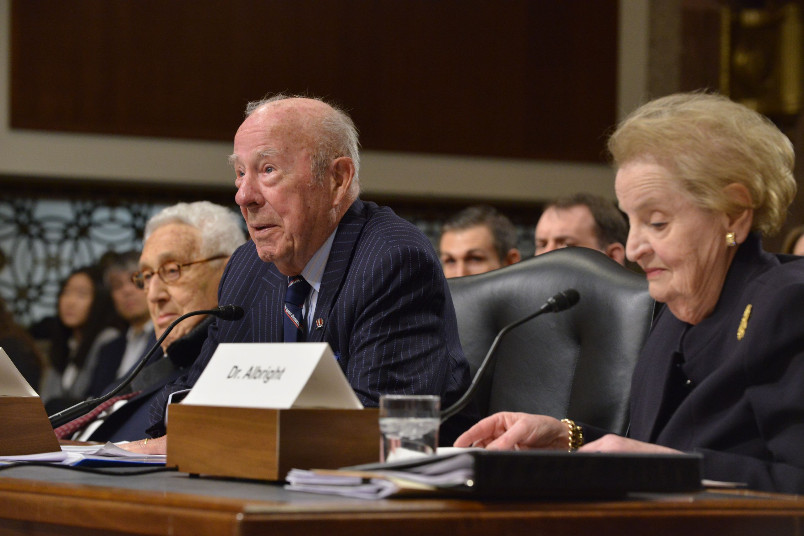Color photograph of Former Secretary of State George Shultz testifies before the Senate Armed Services Committee in a hearing on national security strategy alongside Madeleine Albright and Henry Kissinger. January 29, 2015. Photo: Jay Mallin