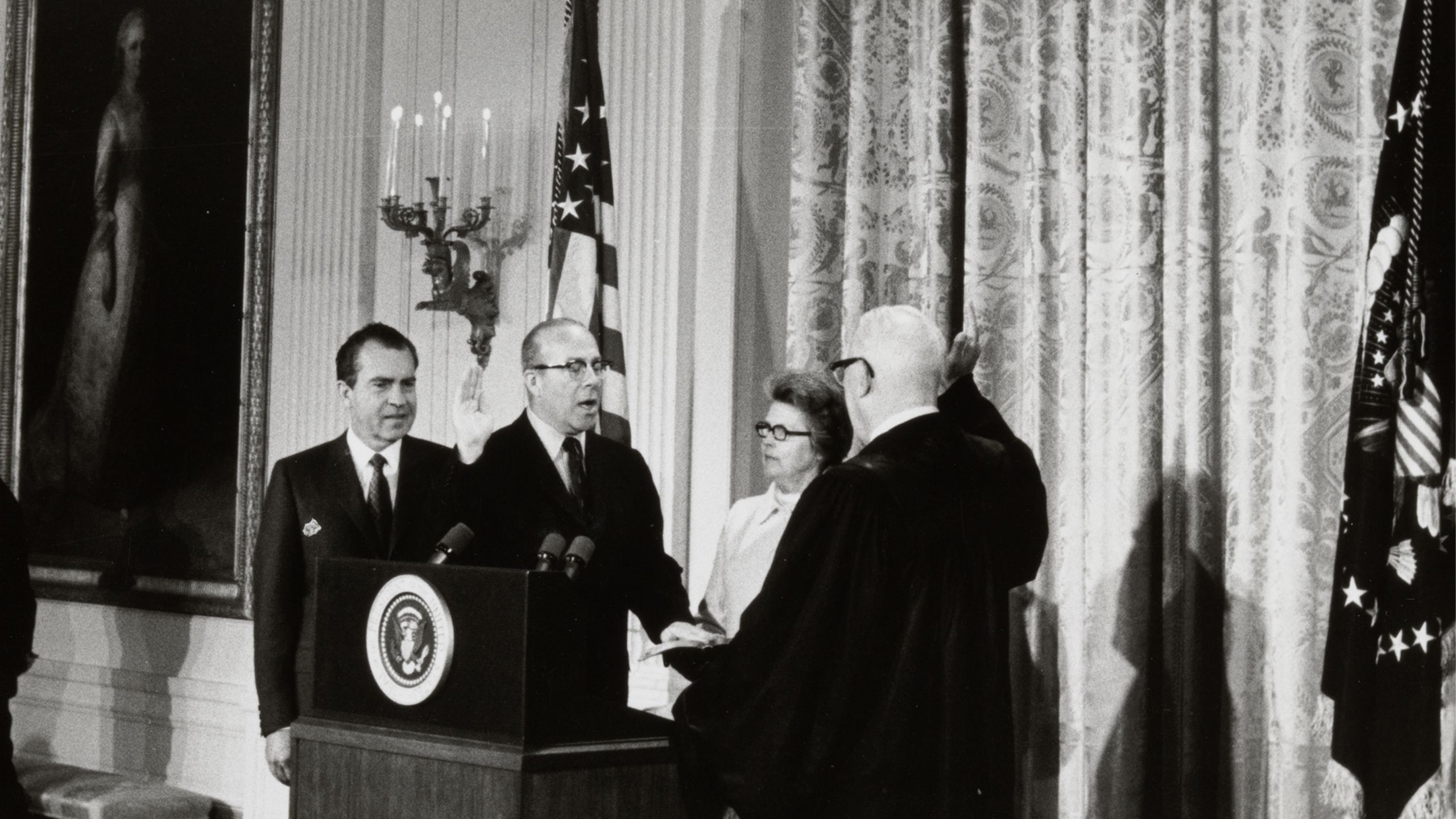 Black and white photograph showing George Shultz being sworn in as Secretary of Labor by Chief Justice Earl Warren, January 22, 1969. George P. Shultz papers